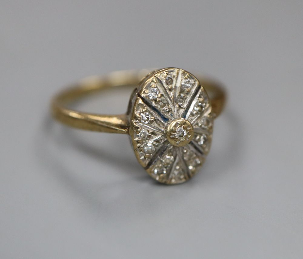 A 9ct gold and diamond chip set oval cluster ring, size M/N, gross 2.1 grams.